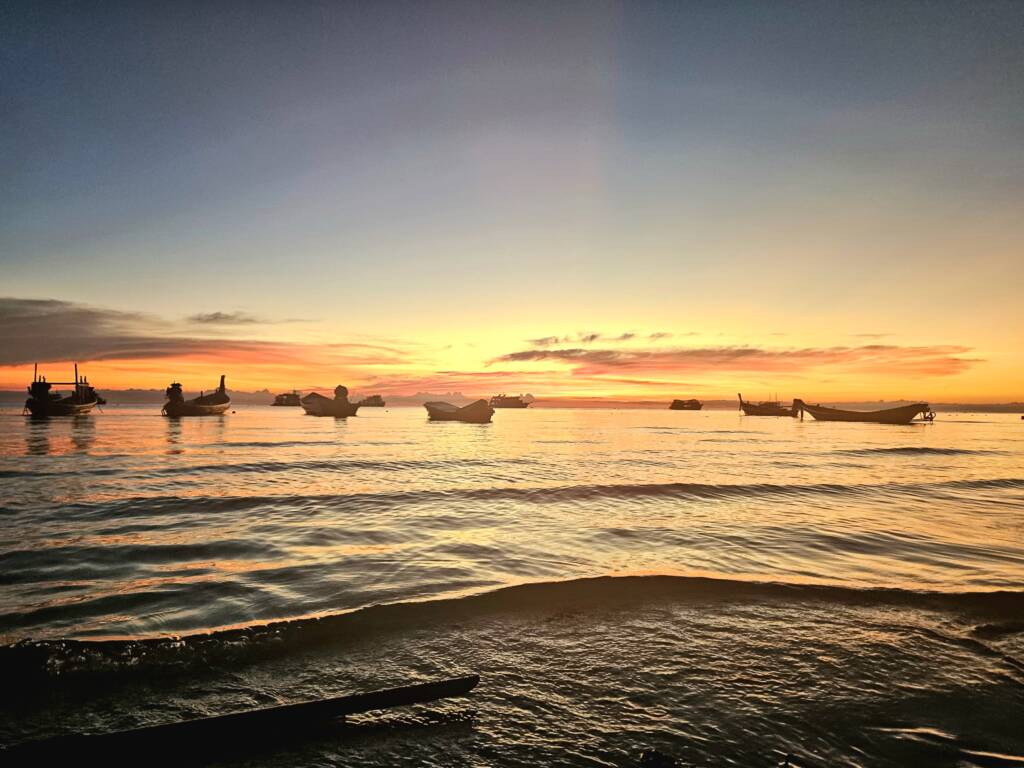 Sunset over sea with Longtail boats at Sairee Beach, Koh Tao, Thailand. 
