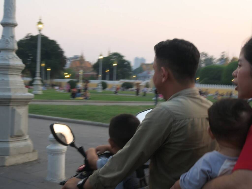 family riding scooter in Phnom Penh, Cambodia