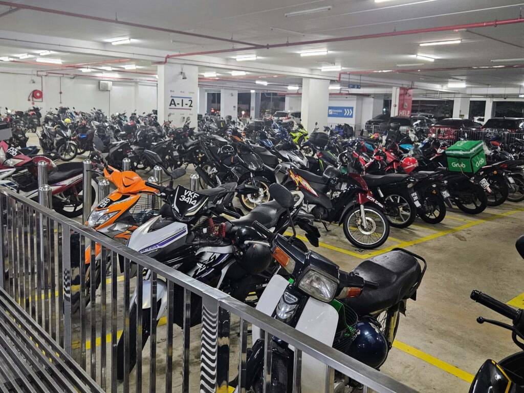 busy carpark filled with scooters in Malaysia