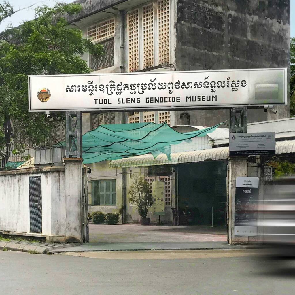 Exterior gate and signage of the Tuol Sleng Genocide Museum (S21) Phnom Penh, a key site for responsible travel in Cambodia.