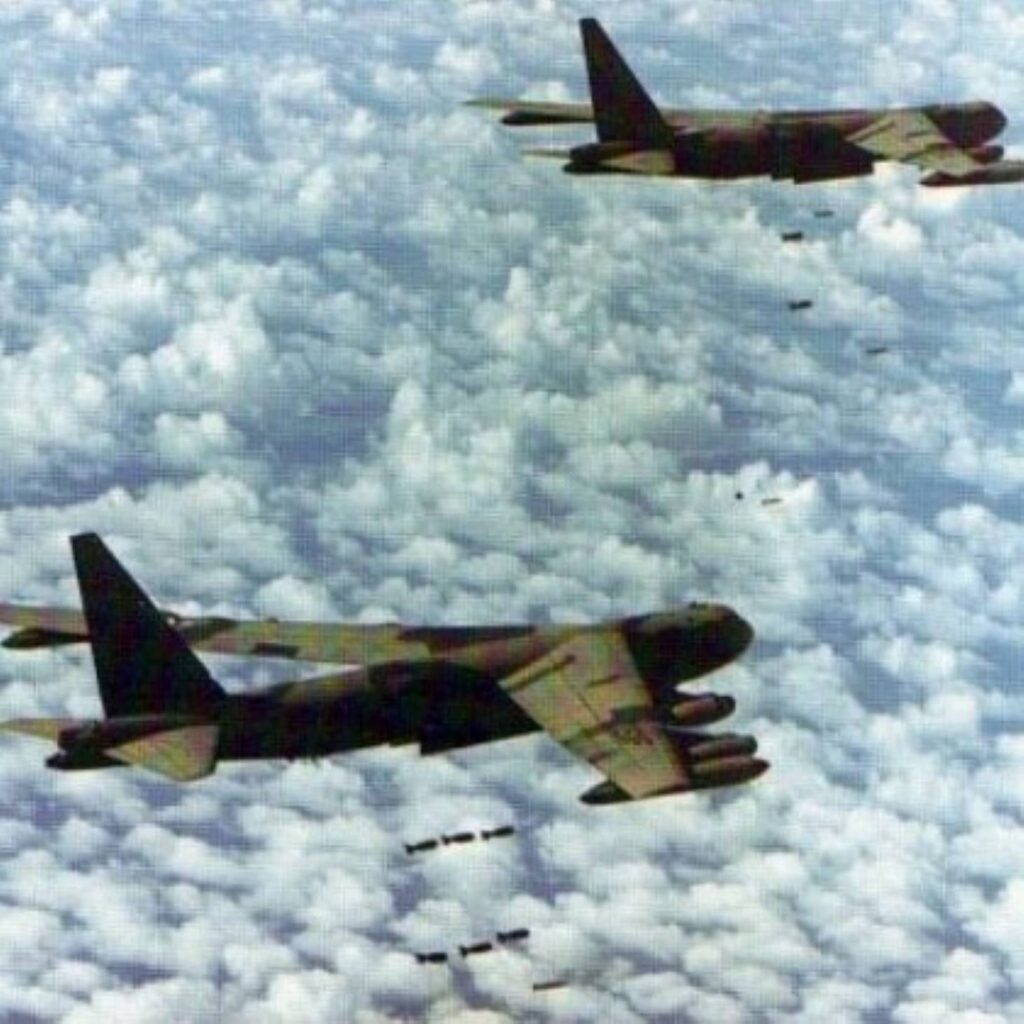 B-52 bombers dropping ordnance on Cambodia through clouds.
