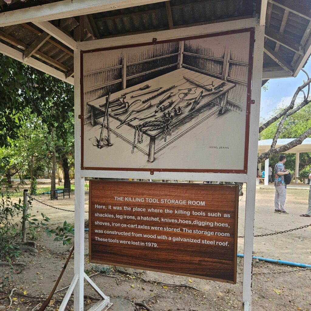 A sign showing a drawing of "KILLING TOOL STORAGE ROOM" with implements (shackles, hoes, axes).