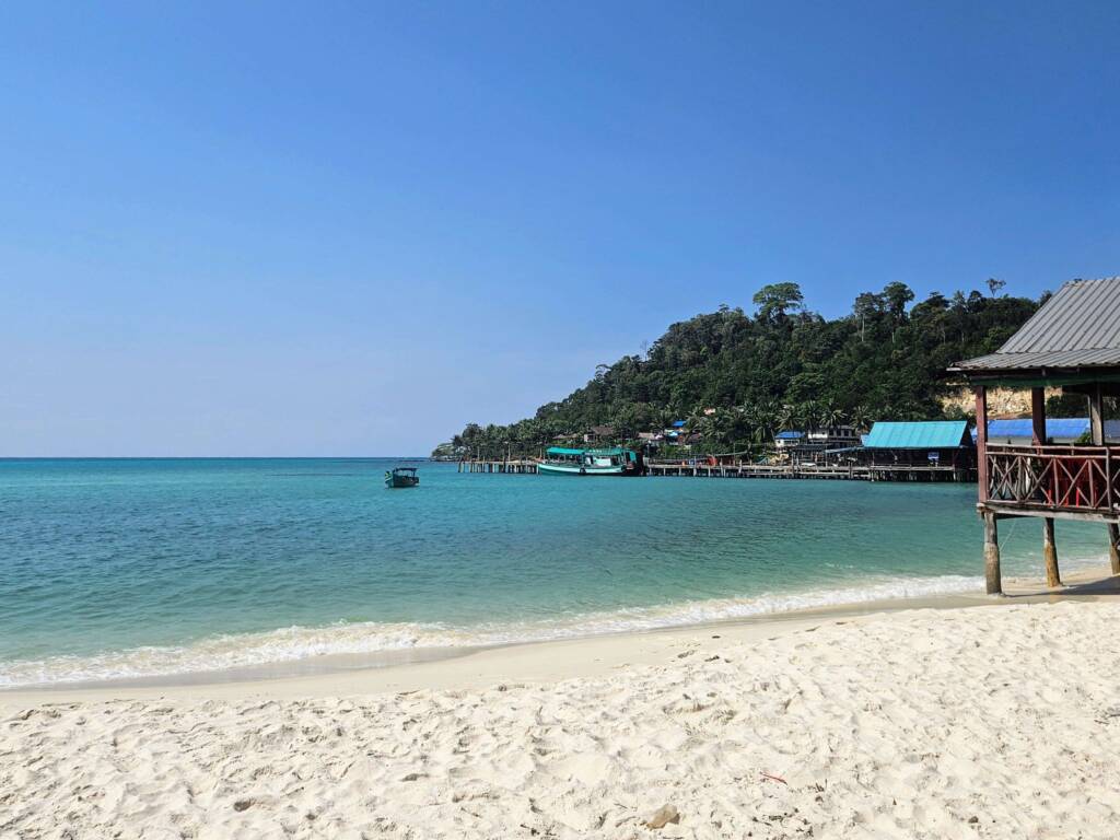 Perfect dry season weather in Southeast Asia showing a pristine beach, turquoise water, and clear blue sky.