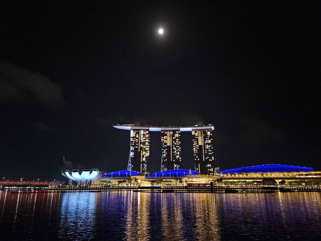 Marina Bay Sands Hotel at night under a full moon, a great free attraction for a Singapore budget itinerary